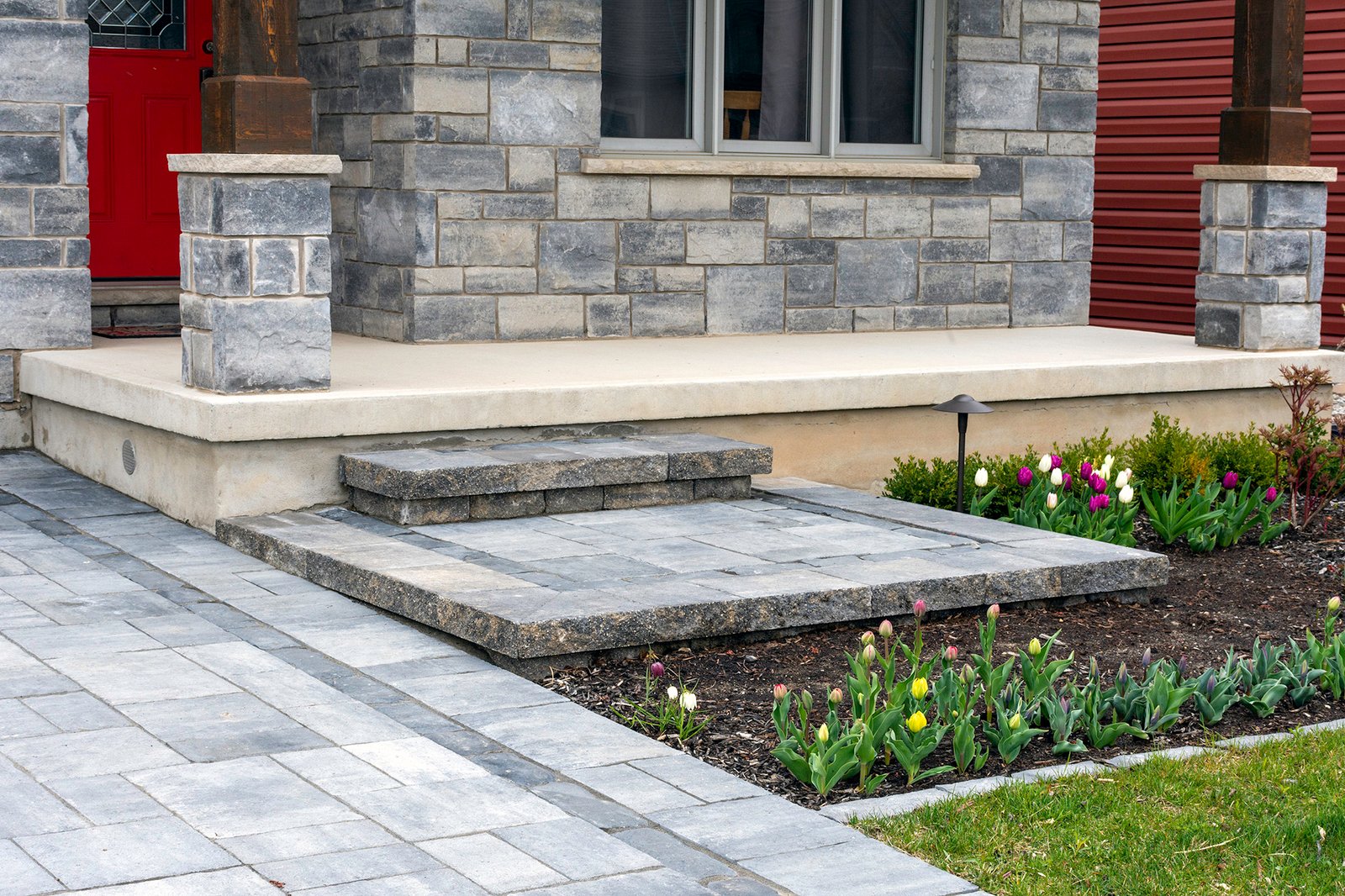 Closeup of front residential luxury landscaping for a smaller home. Closeup of front residential luxury landscaping for a smaller home.